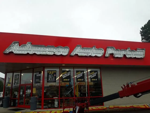 All faces off, crane truck on site inside the Advance Auto Parts letters with the sign faces still off
