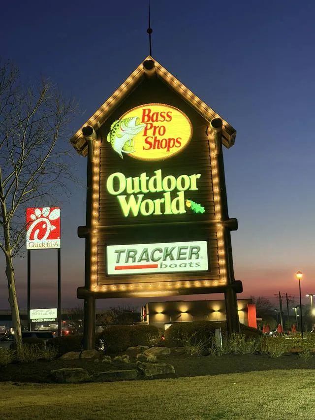 Bass Pro Shops Outdoor World pylon sign lit at dusk after its completed UL-listed LED retrofit by Seiz Sign Company