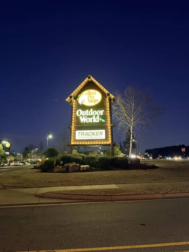 Bass Pro Shops Outdoor World pylon sign lit at night after its completed UL-listed LED retrofit
