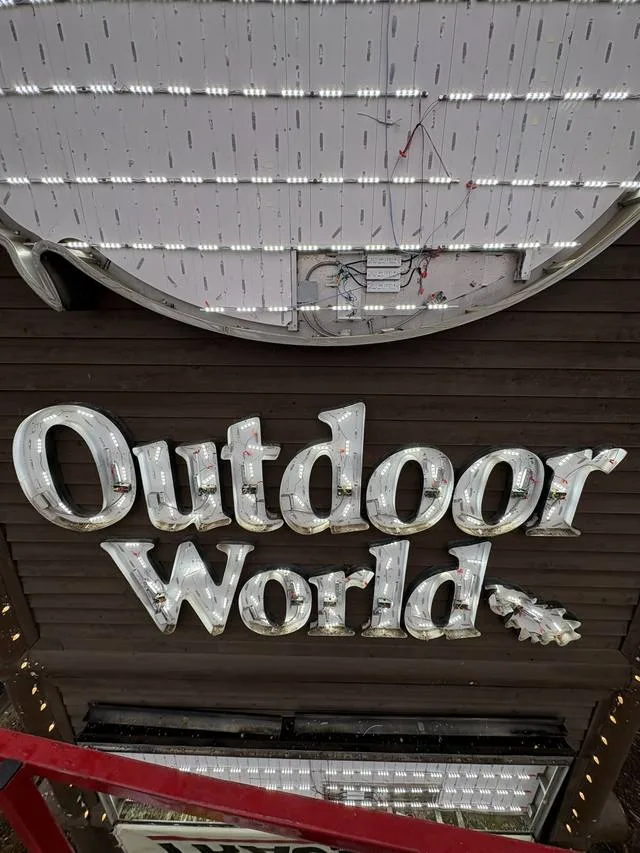 Close-up of UL-listed LED modules fitted behind the Bass Pro Shops Outdoor World letters during the retrofit