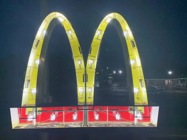 Close view of the McDonald's arches sign mid-retrofit with UL-listed LED modules exposed
