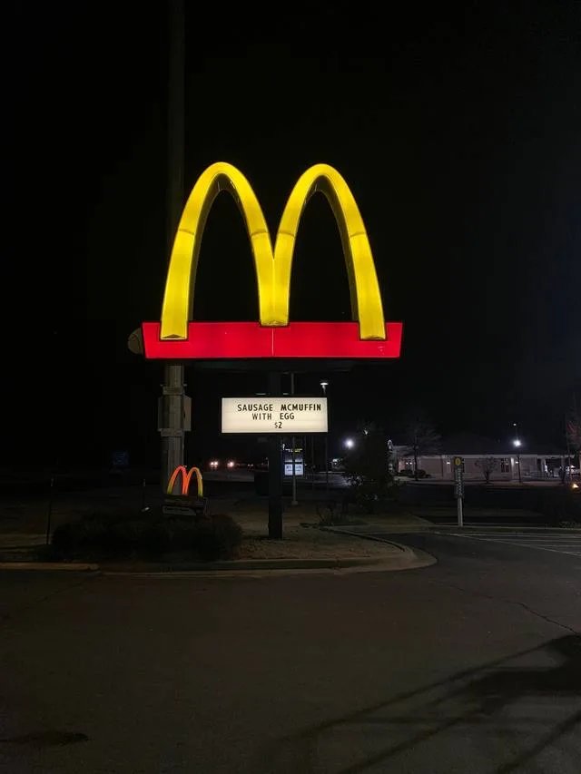 Wide night view of the completed McDonald's arches pylon sign with UL-listed LED illumination